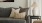 a couch with pillows and a lamp