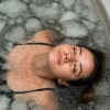 a woman laying in an ice bath