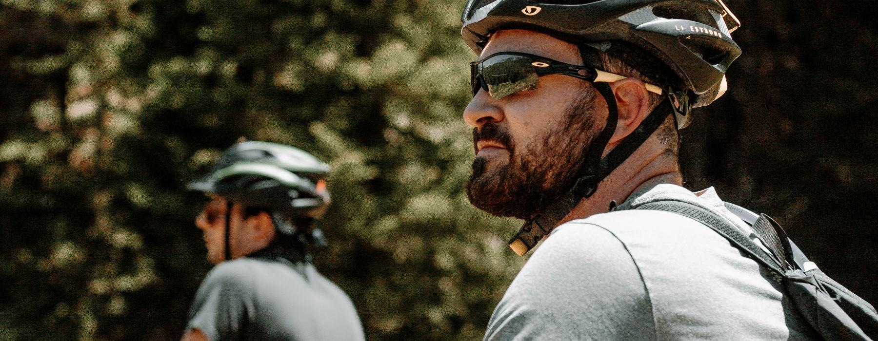 a two men riding bicycles